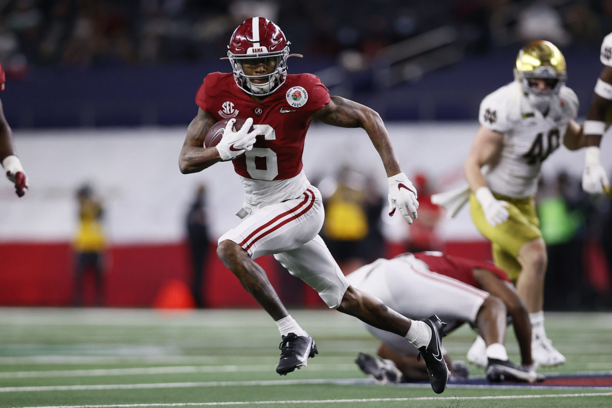 Wide receiver DeVonta Smith #6 of the Alabama Crimson Tide carries the ball for a touchdown