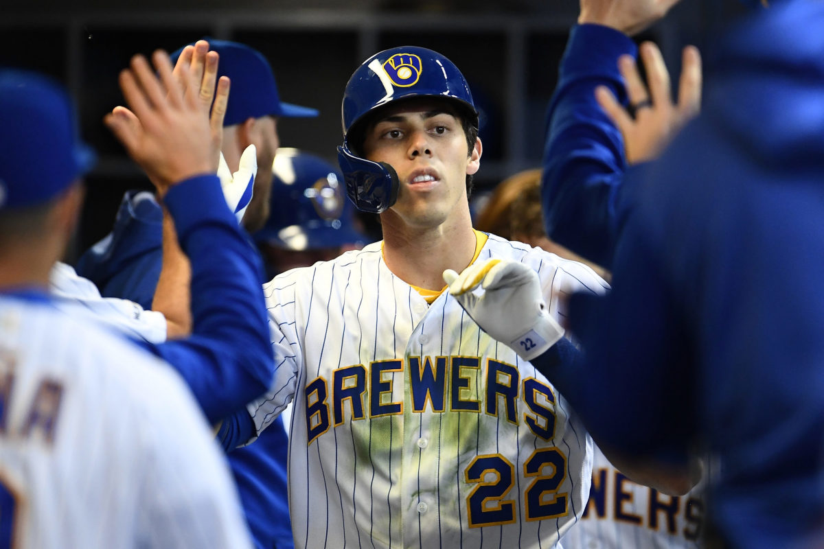 Christian Yelich celebrating in the dugout.