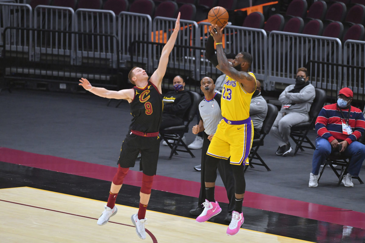 LeBron James #23 of the Los Angeles Lakers shoots over a Cavaliers defender