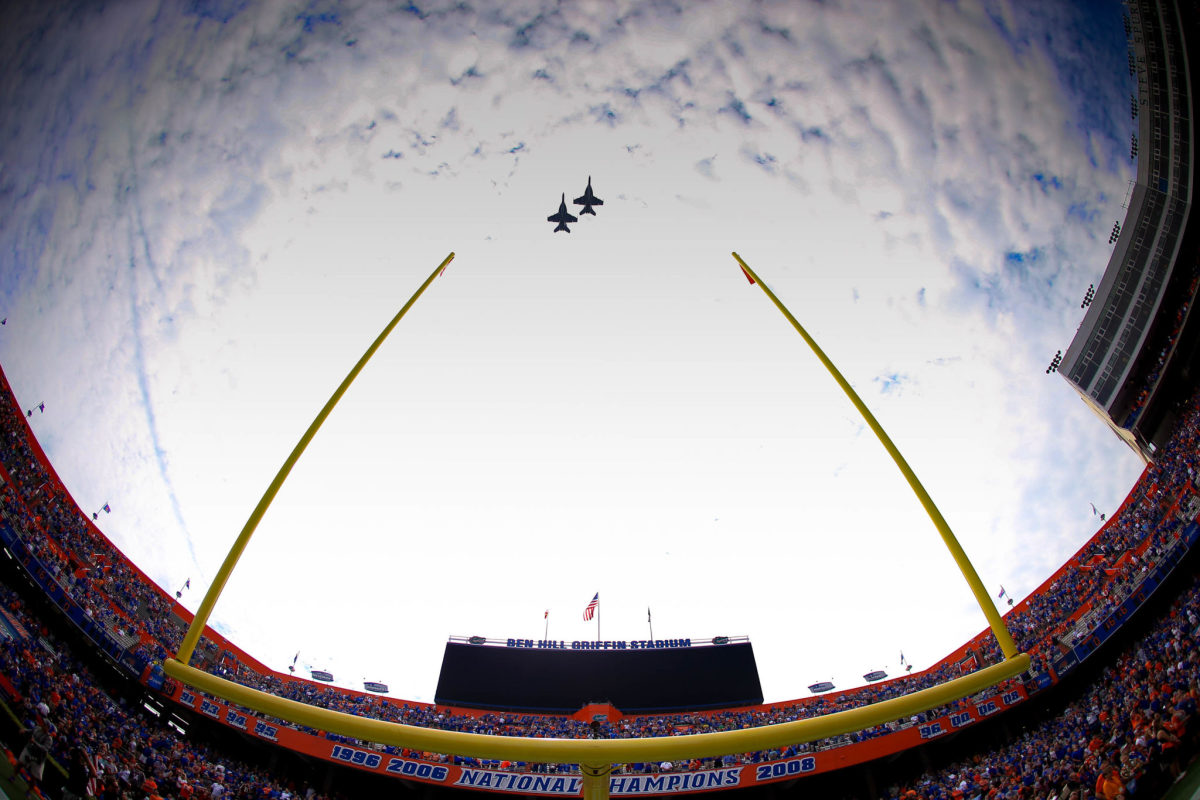 An interior view of the Florida Gators football stadium as two jets fly above.
