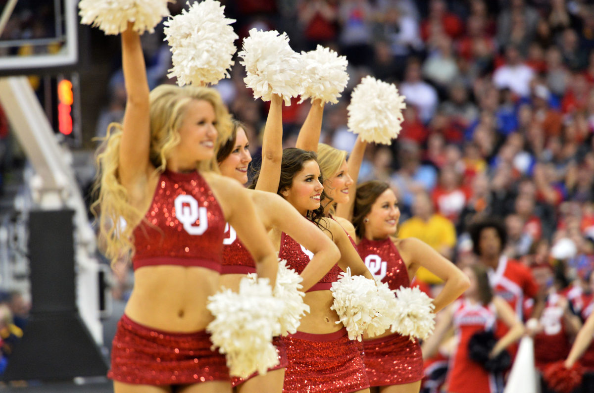Oklahoma Cheerleaders performing at a basketball game.