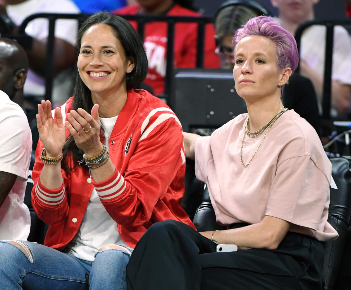 Megan Rapnioe and Sue Bird sit at the WNBA All-Star Game.