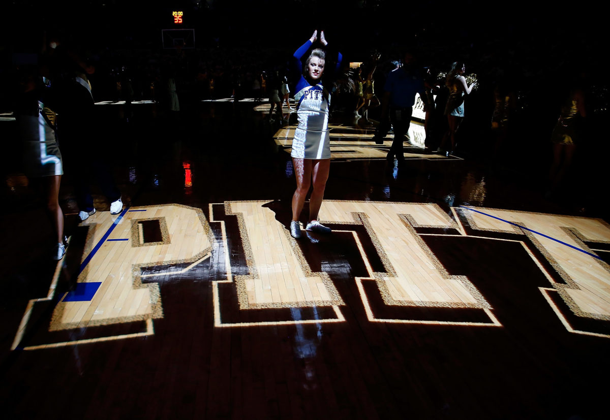 A Pitt cheerleader on the basketball court.