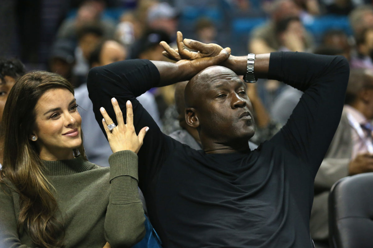 Michael Jordan at an NBA game with his wife.