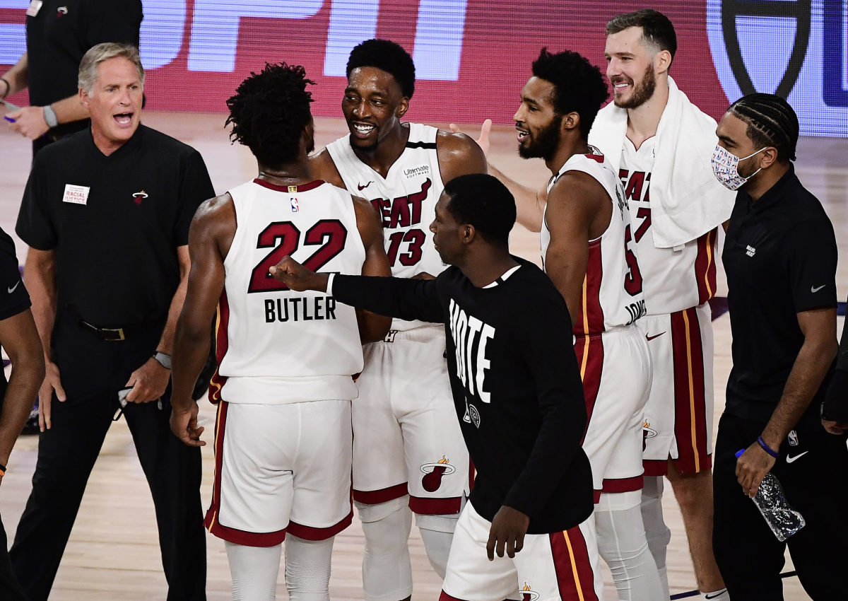 Bam Adebayo celebrates with teammates including Miami Heat star Jimmy Butler.
