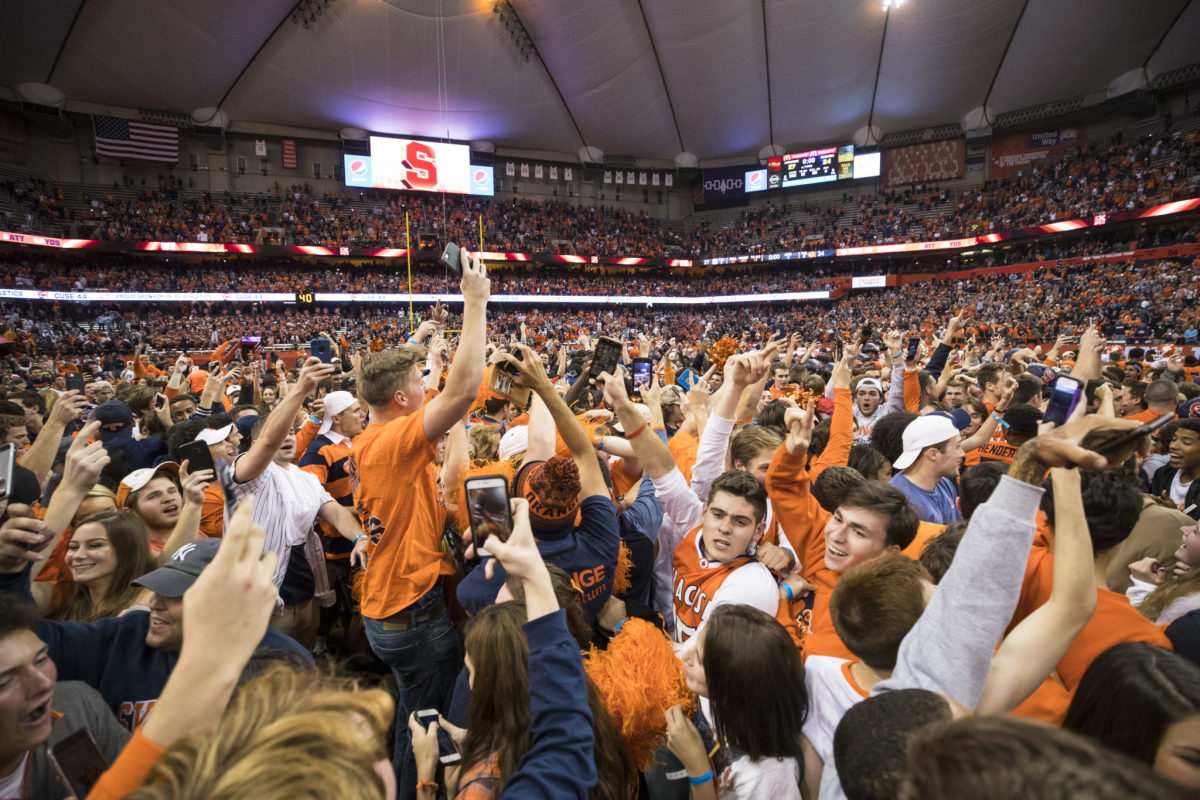 Syracuse football fans storm the field after beating Clemson.
