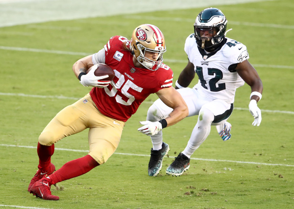George Kittle runs with the ball for the 49ers.