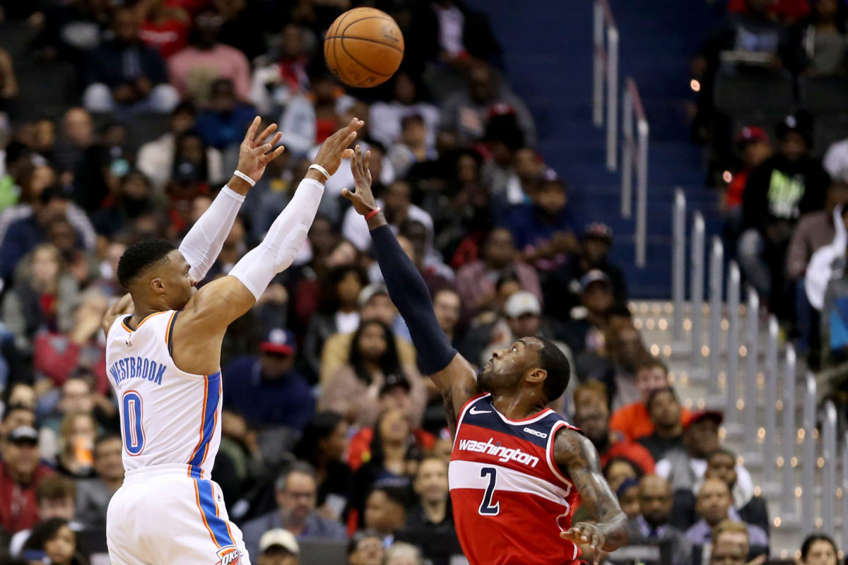 Russell Westbrook shoots over John Wall during a Thunder vs. Wizards game in 2018.