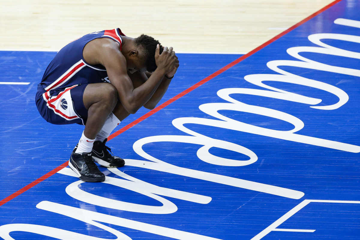 Washington Wizards center Thomas Bryant holds his head, reacting to a play.