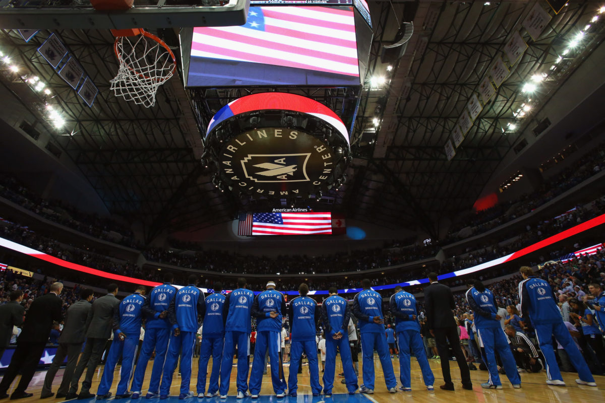 Dallas Mavericks stand for national anthem.