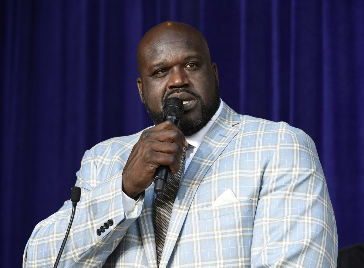 Shaq speaking into a microphone.