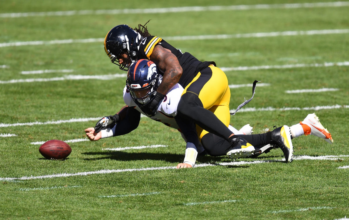 Denver Broncos quarterback Drew Lock sacked by Pittsburgh Steelers outside linebacker Bud Dupree during a game.