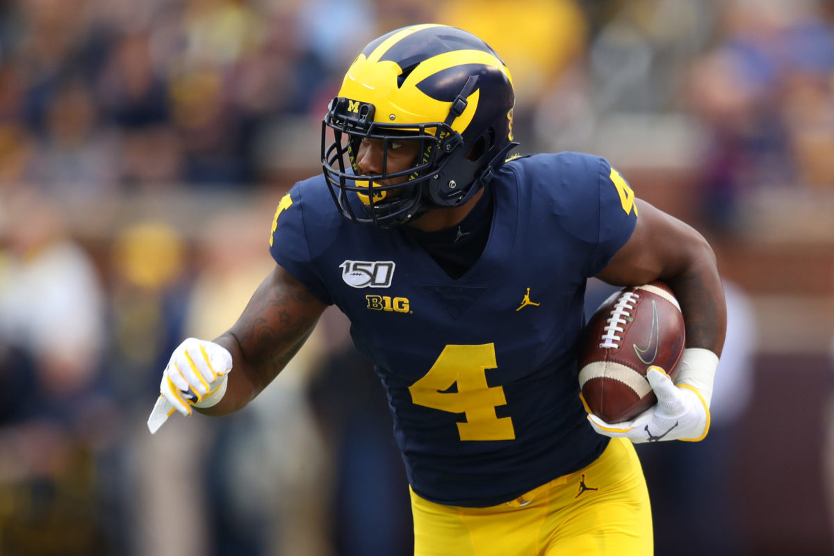 Nico Collins runs with the football for Michigan.