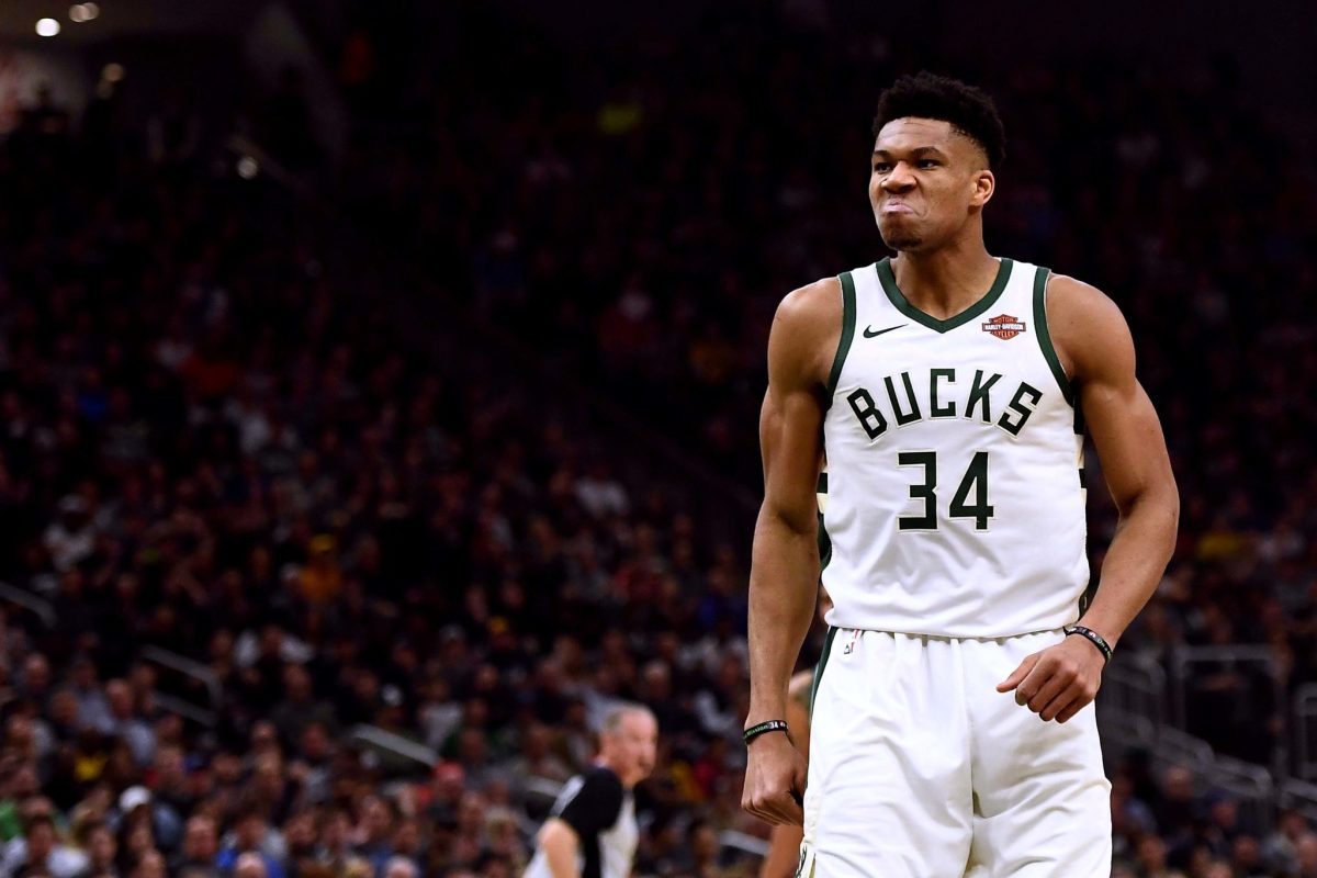 Milwaukee Bucks superstar Giannis Antetokounmpo reacting after dunking the ball during a game.