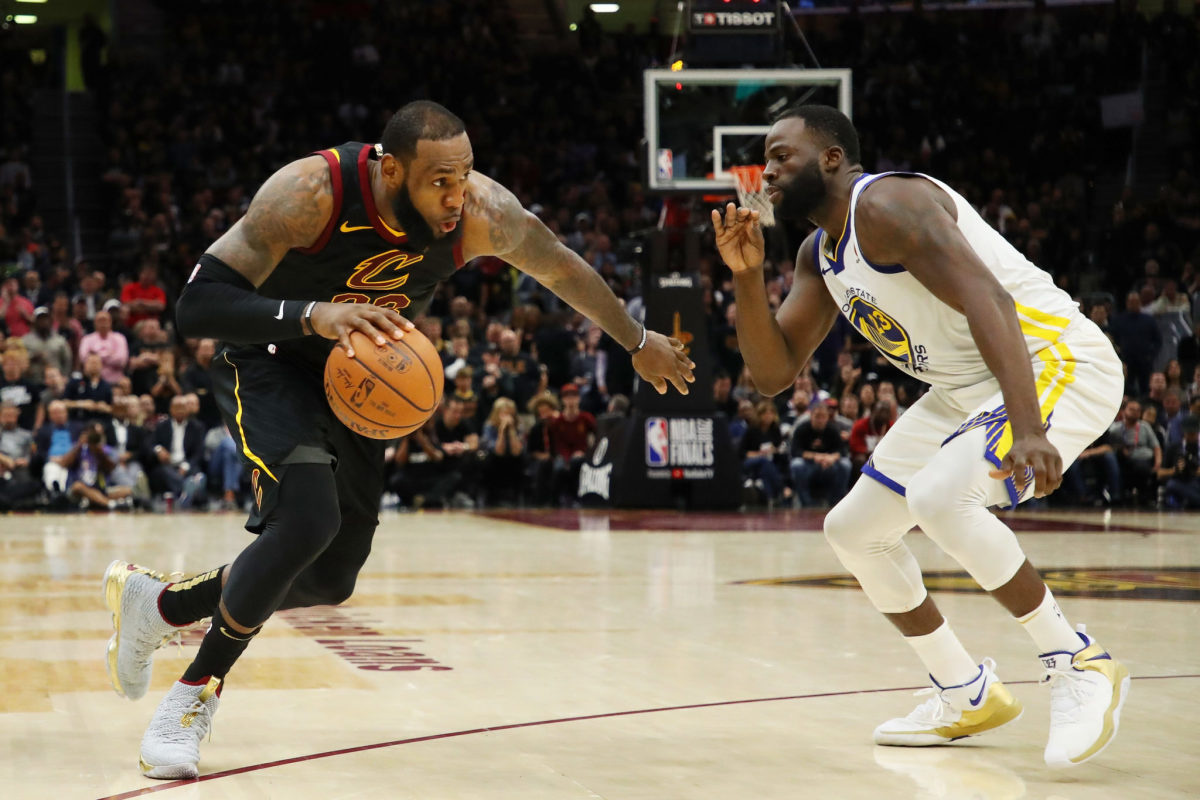 LeBron James #23 of the Cleveland Cavaliers drives against Draymond Green #23 of the Golden State Warriors during Game Three of the 2018 NBA Finals