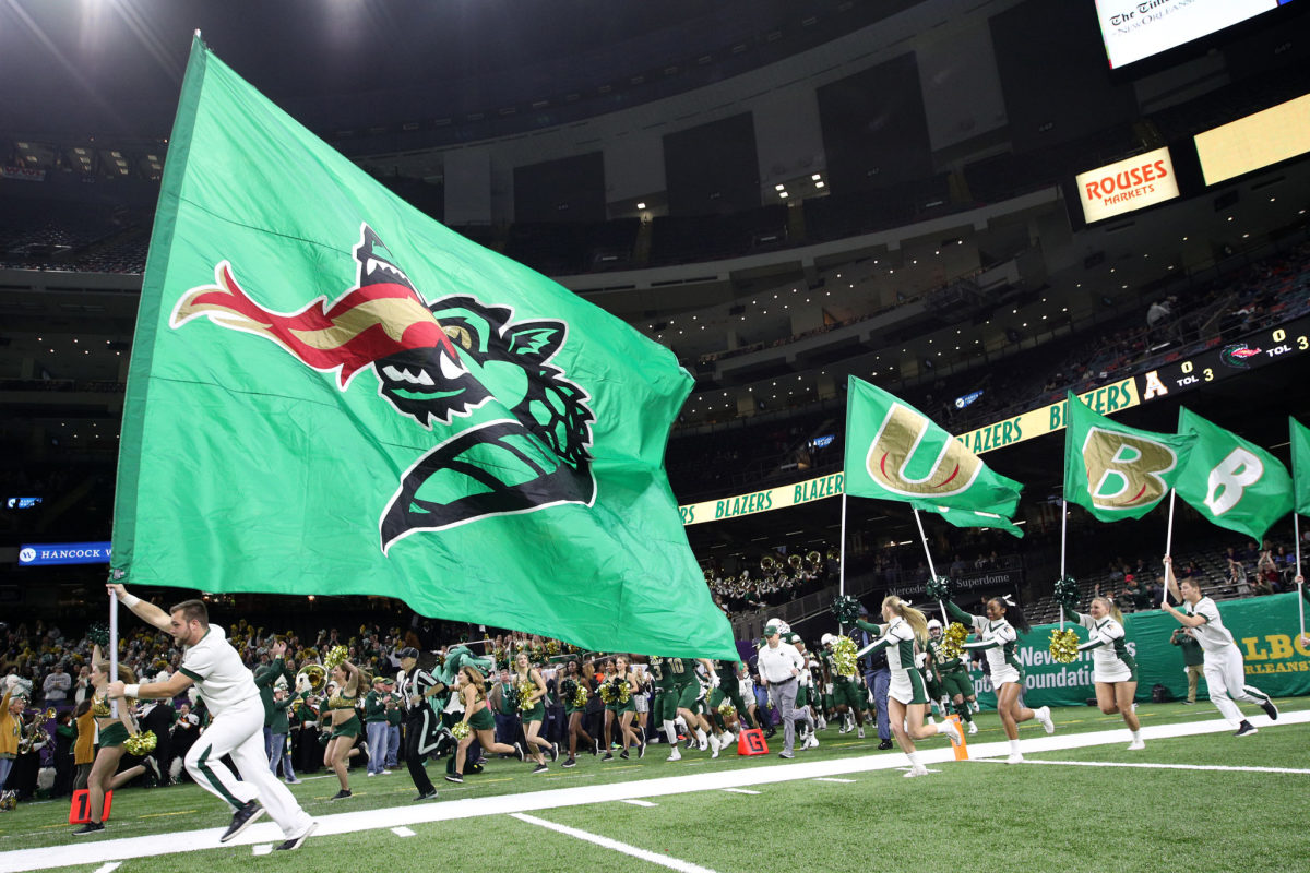 UAB football team takes the field at the Superdome.