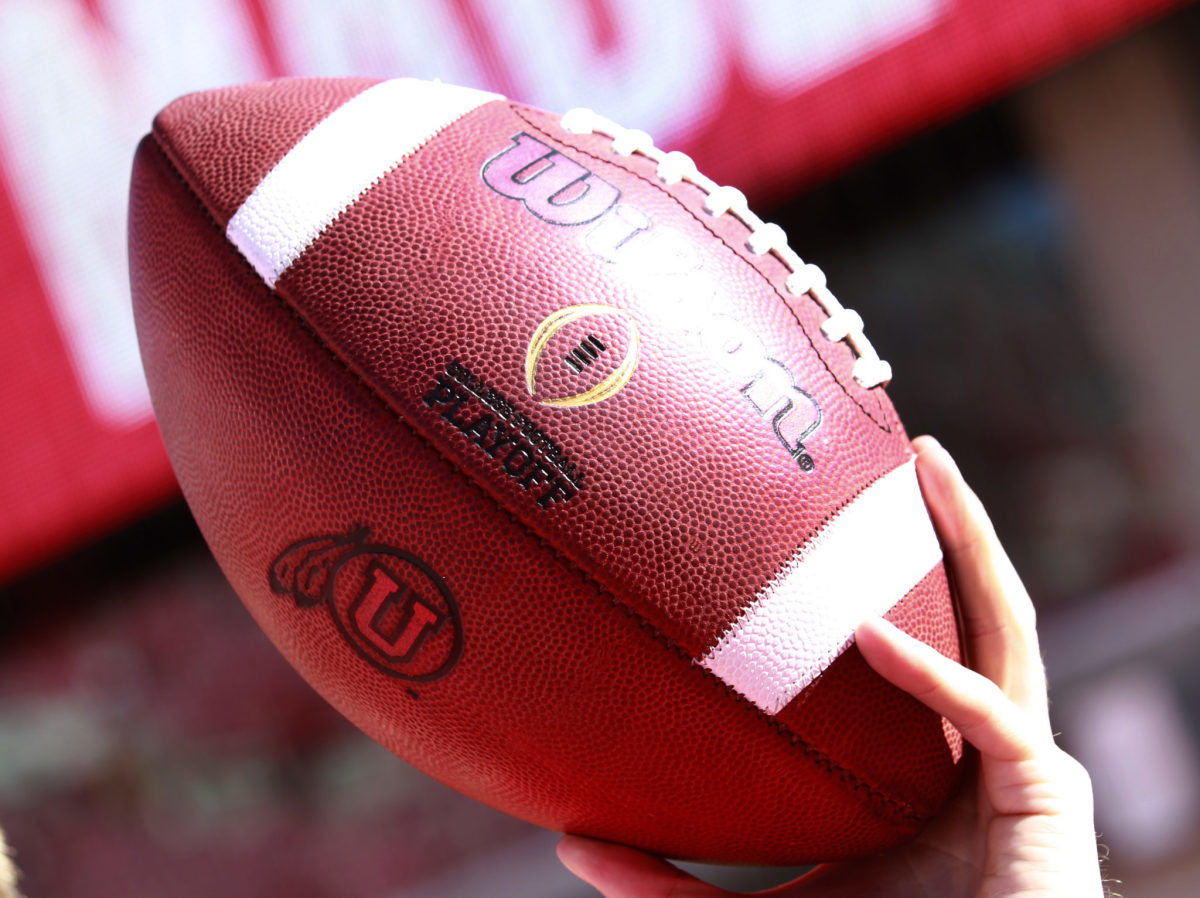 A closeup of a football with the Utah Utes logo on it.