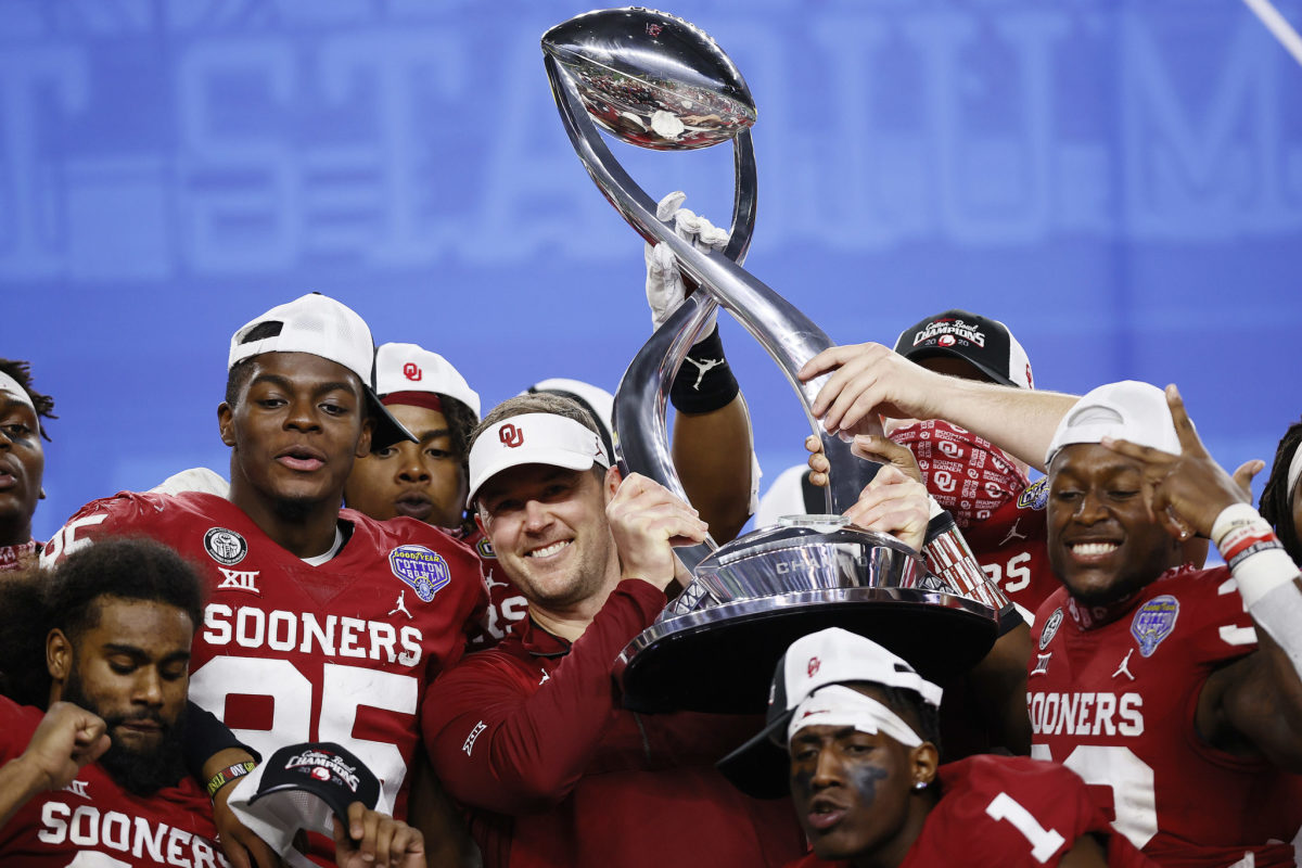 Head coach Lincoln Riley of the Oklahoma Sooners holds up the Cotton Bowl Championship trophy