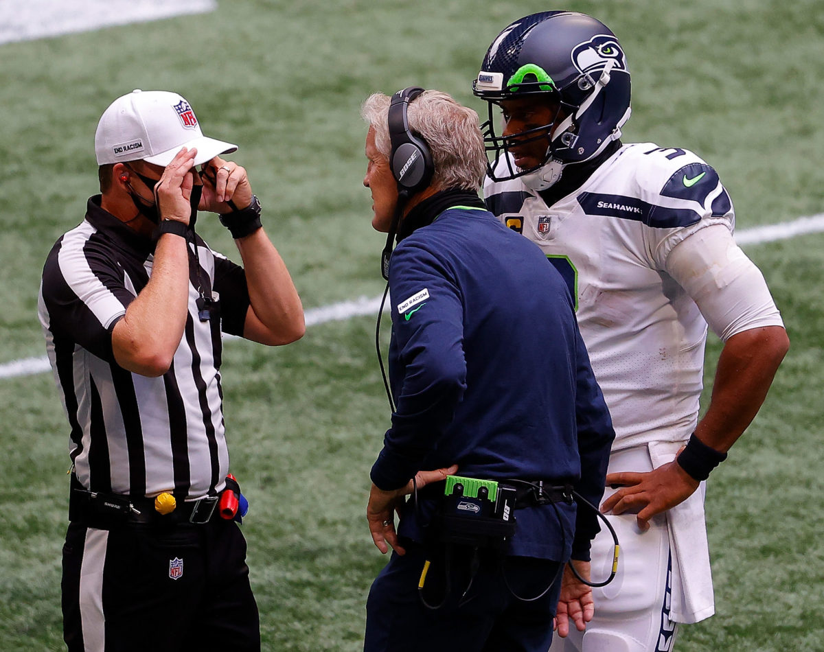 Pete Carroll speaks with an official.