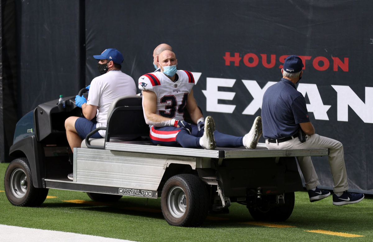 Rex Burkhead #34 of the New England Patriots is carted off the field following an injury