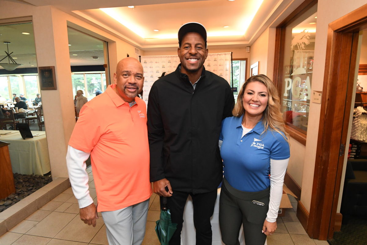 Michael Wilbon, Andre Iguodala and Amanda Balionis pose for a picture.