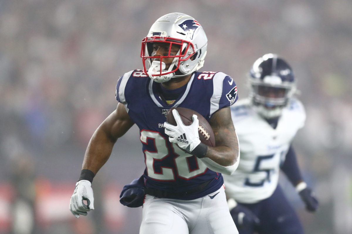 Patriots running back James White carries the ball in a game.