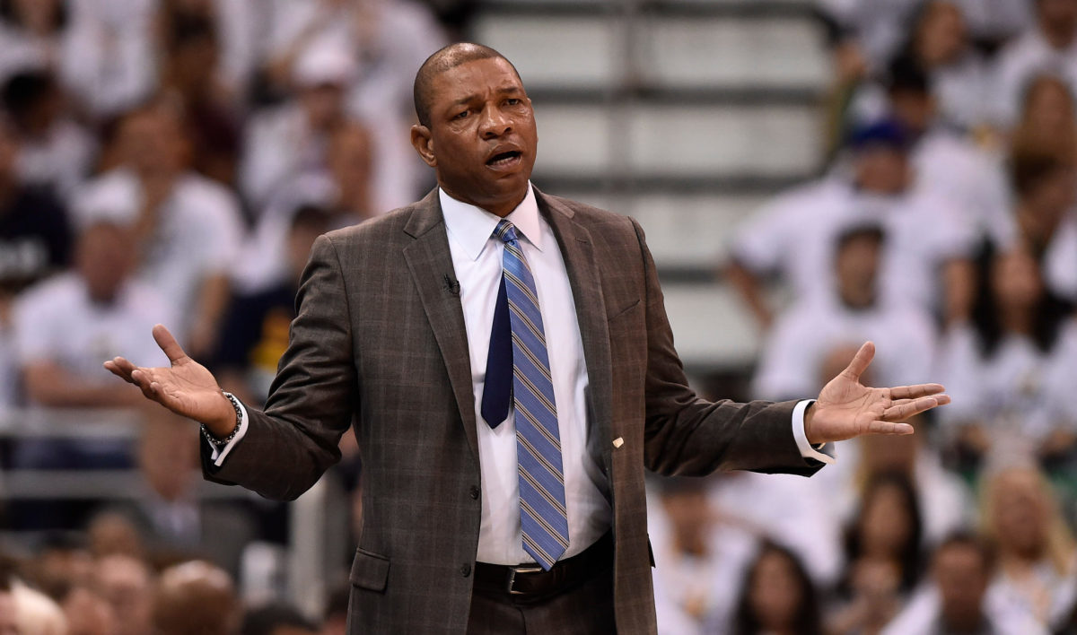 Doc Rivers holding his arms up.