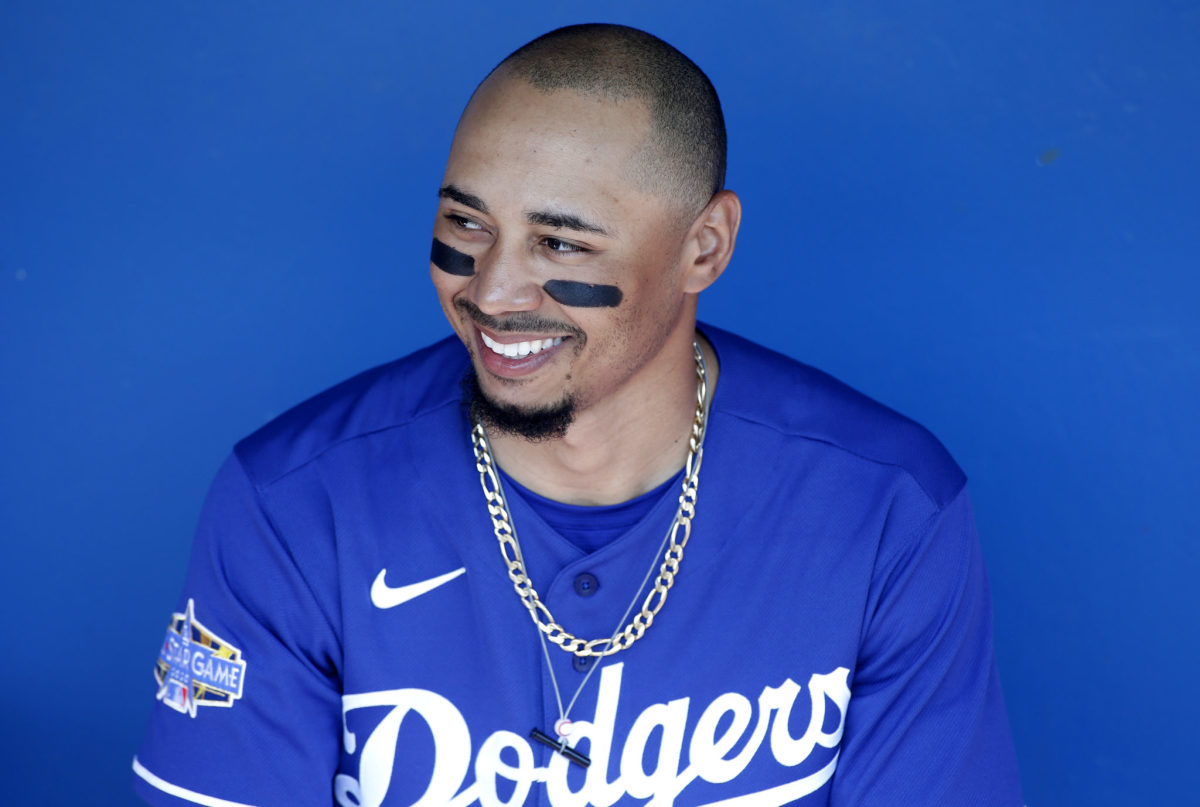 Mookie Betts sits on the bench in his Los Angeles Dodgers jersey.