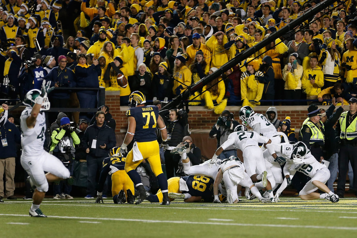 Michigan State players celebrate Jalen Watts-Jackson's punt fumble recovery touchdown against Michigan in 2015.
