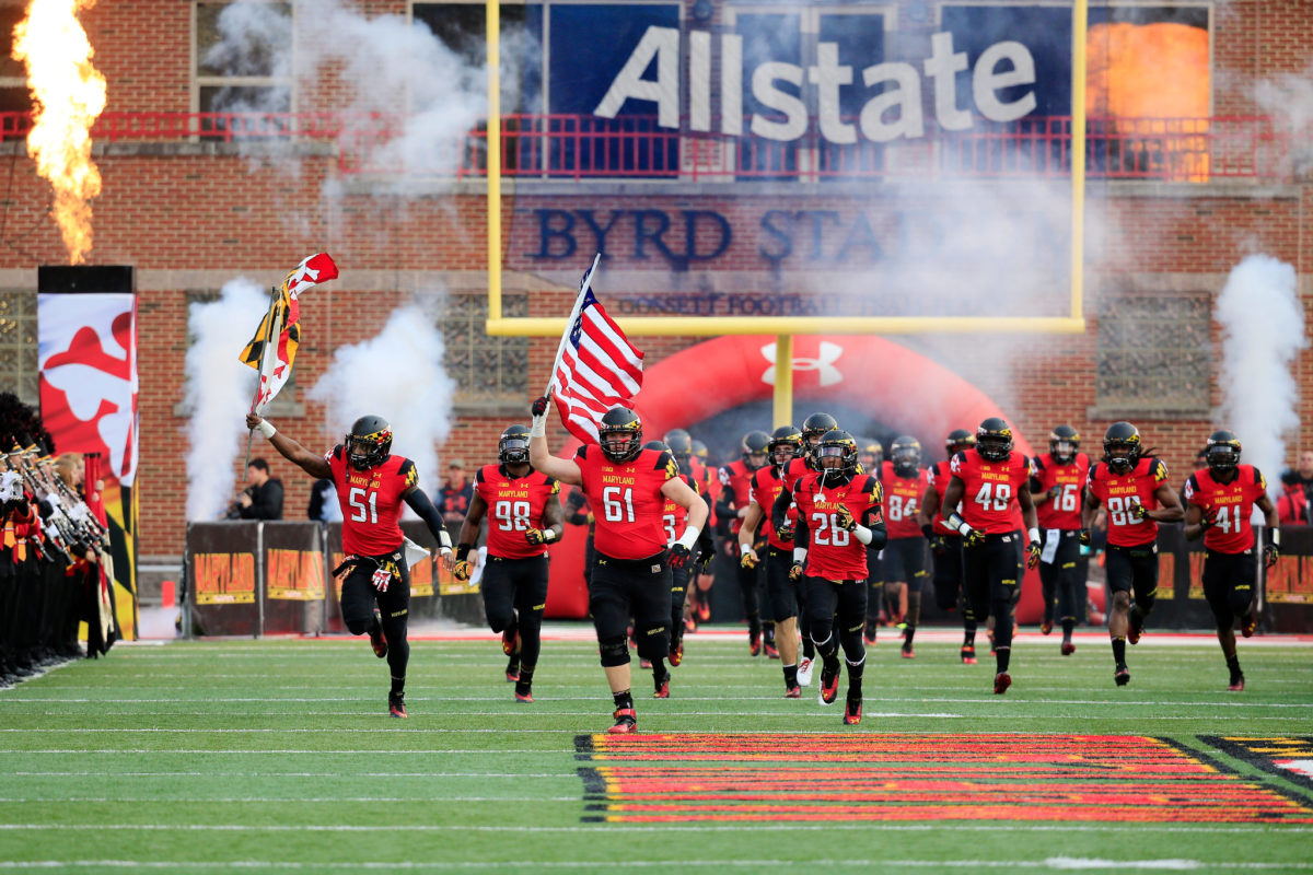 Maryland college football players running onto the field.