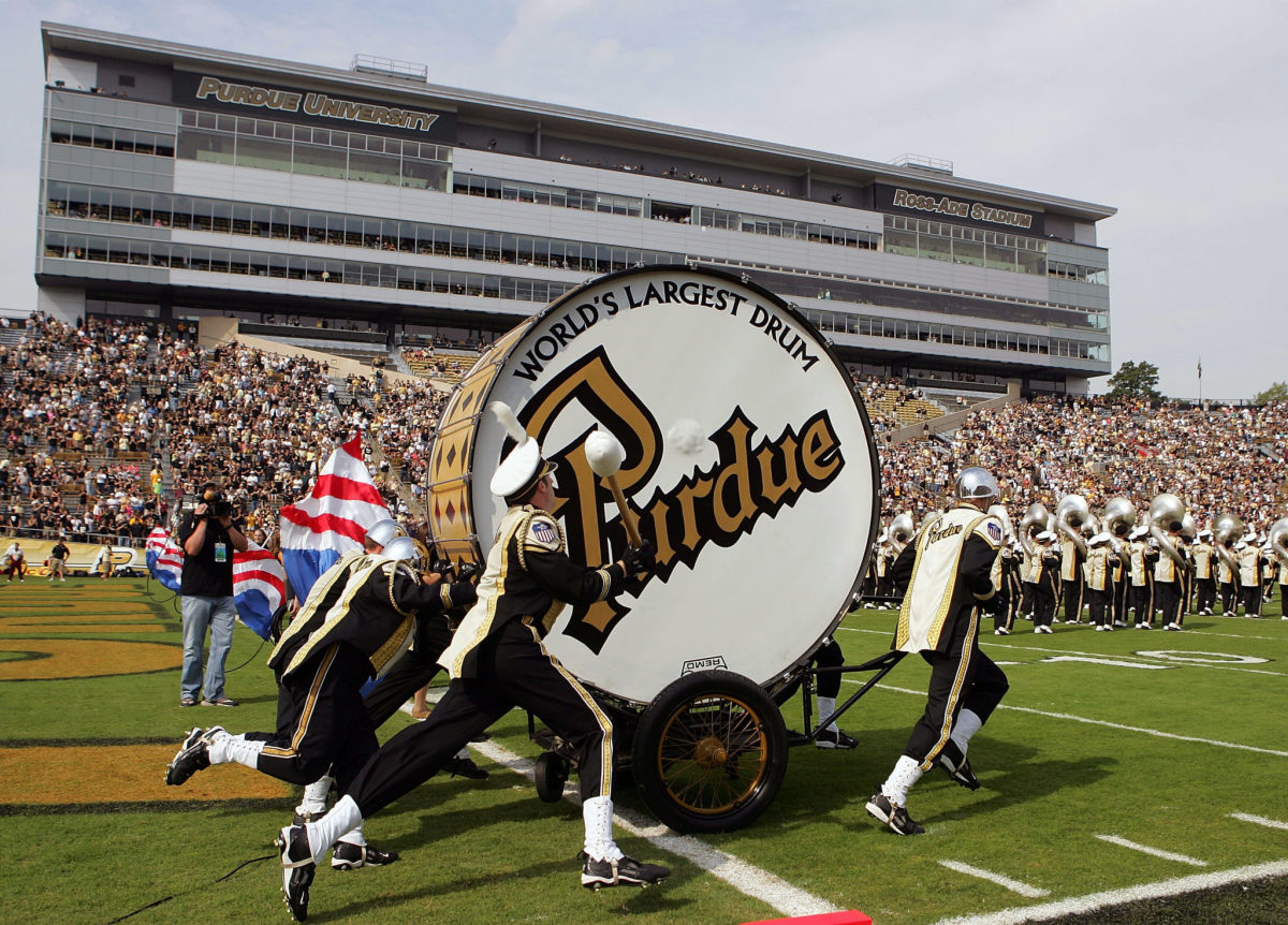 Purdue's band bringing a giant bass drum onto the field.