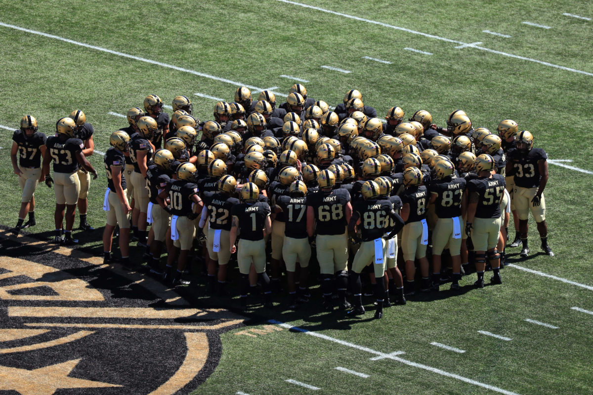 The Army Black Knights huddle