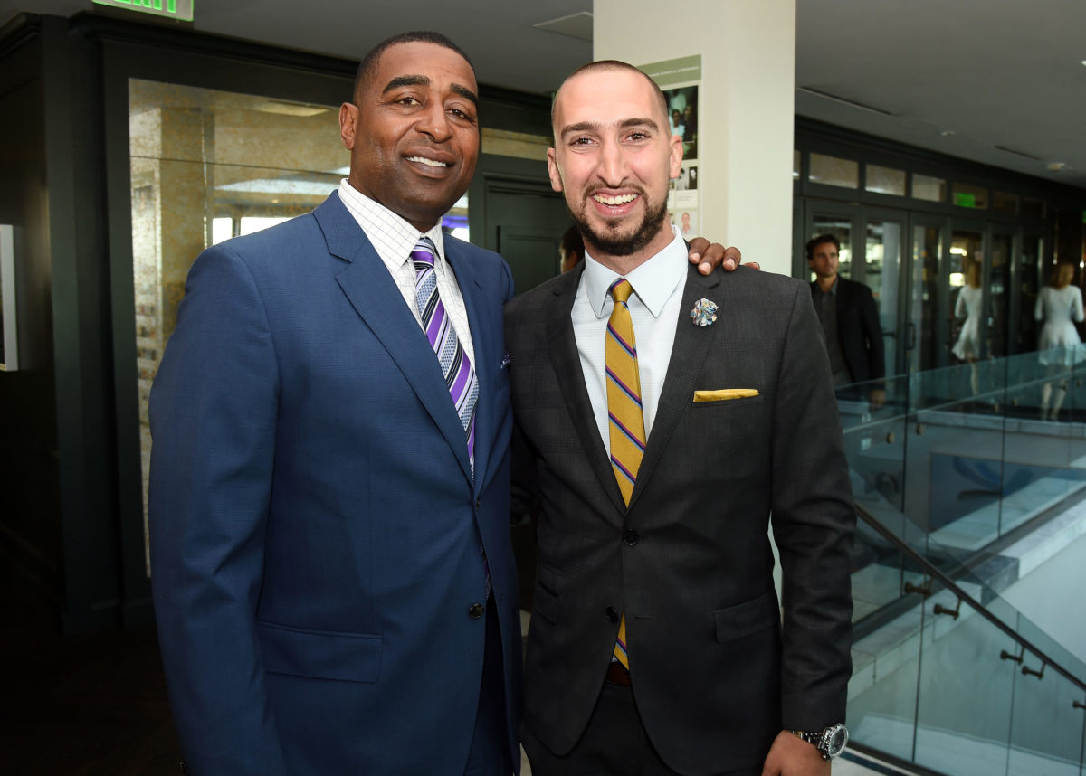 Cris Carter and Nick Wright posing for a photo together.