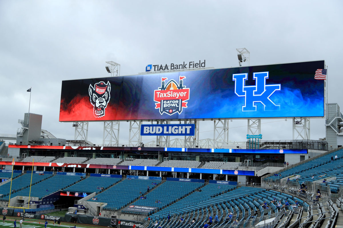 Signage is displayed for TaxSlayer Gator Bowl game between the Kentucky Wildcats and the NC State Wolfpack