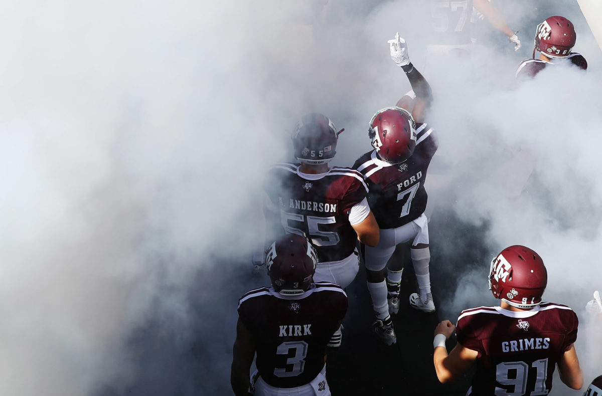 Texas A&M football players walking out to the field.