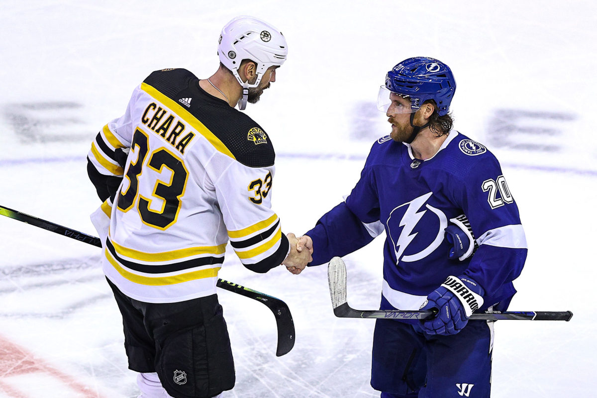 Zdeno Chara shakes hands with an opponent before an NHL game.
