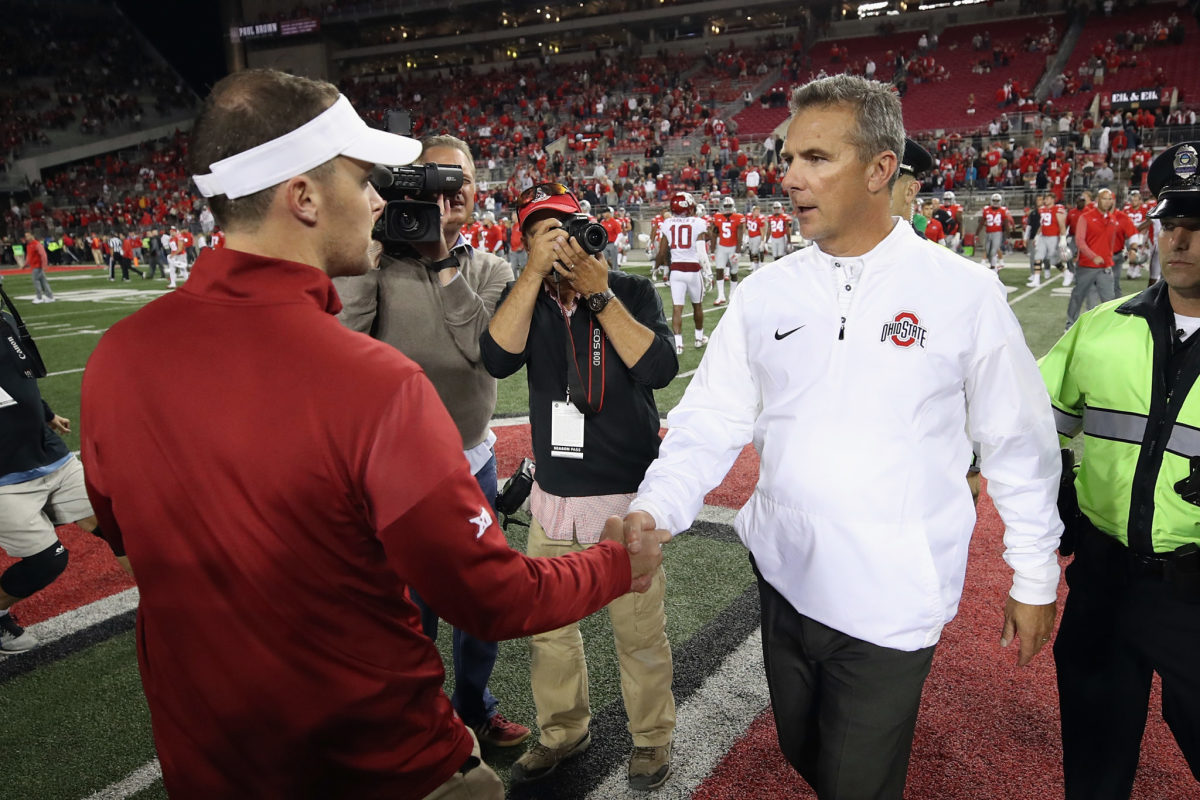 Urban Meyer and Lincoln Riley shaking hands after a game.