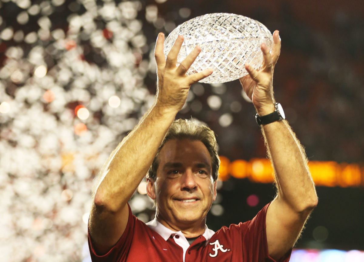 Head coach Nick Saban of the Alabama Crimson Tide celebrates with the trophy after defeating the Notre Dame Fighting Irish in the 2013 Discover BCS National Championship game.