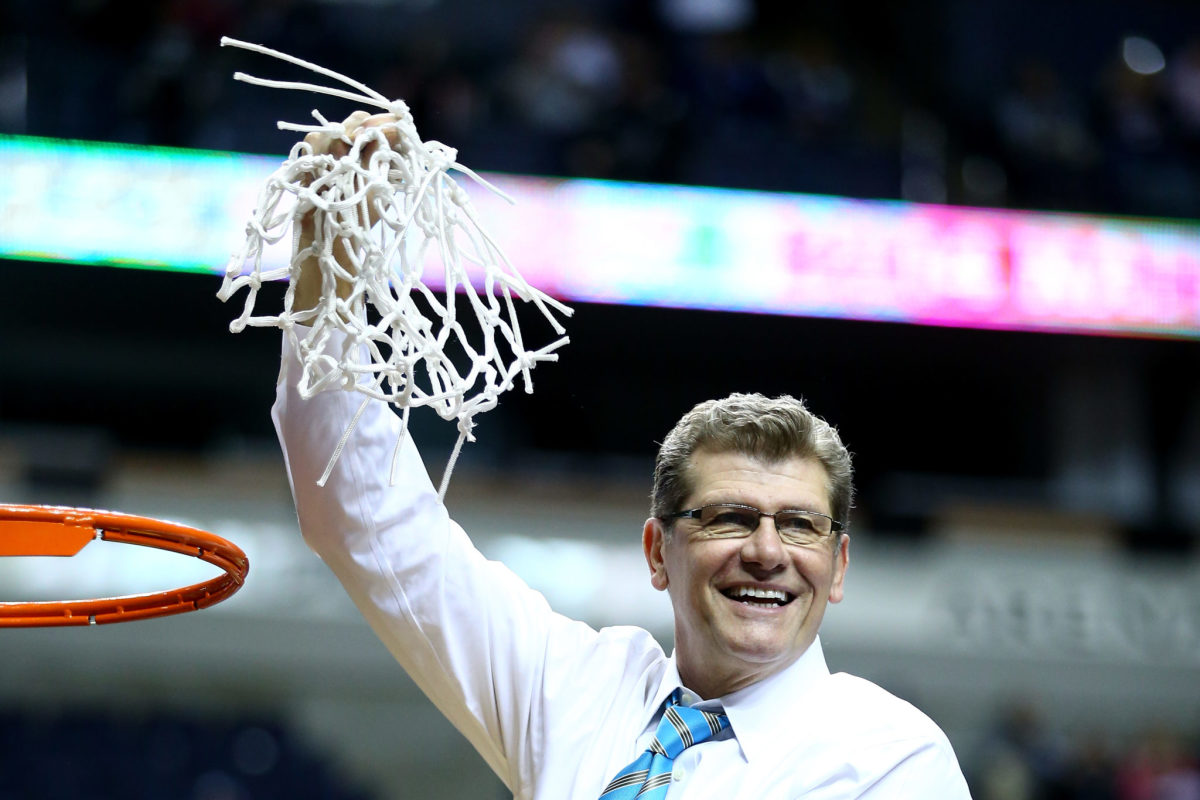 Geno Auriemma holding the net after cutting it down.