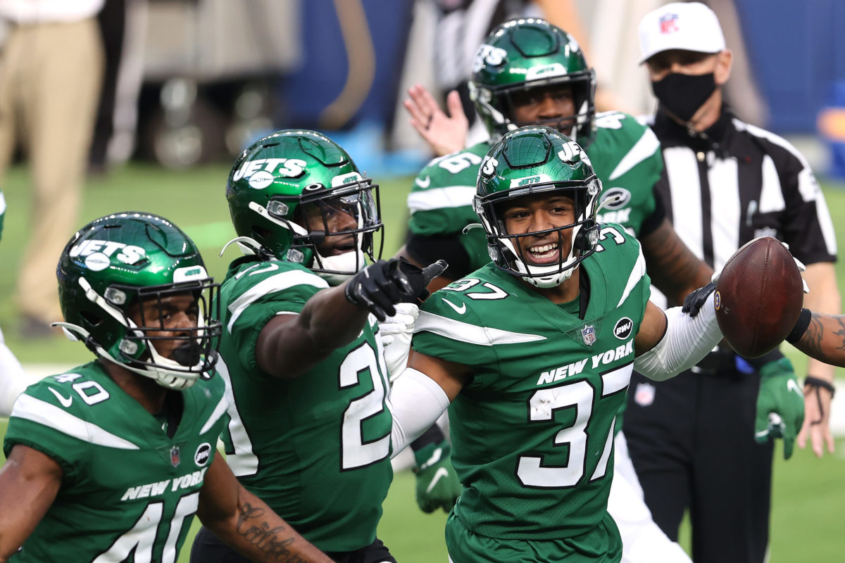 Jets players celebrating after scoring a touchdown.