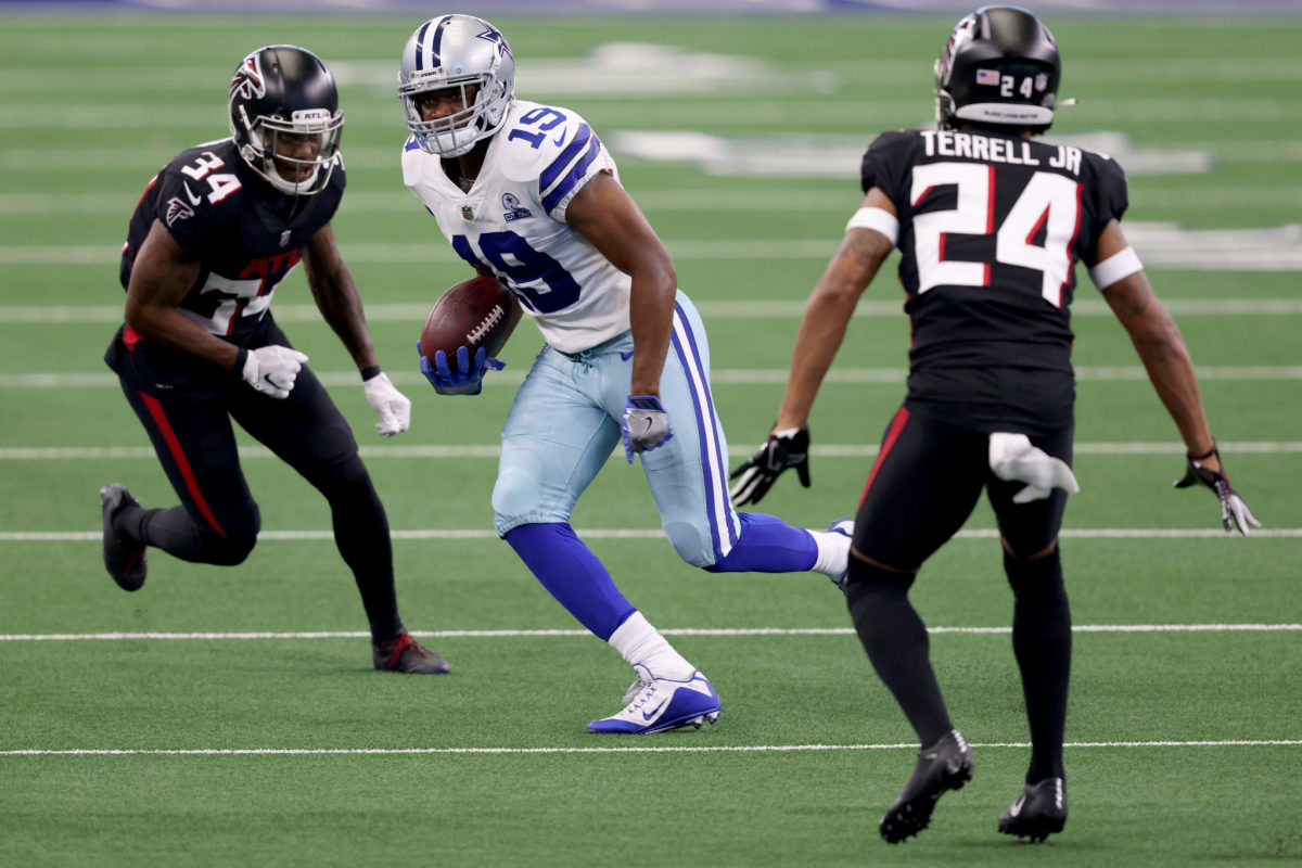 Dallas Cowboys receiver Amari Cooper with the ball, with Atlanta Falcons CB A.J. Terrell in pursuit.