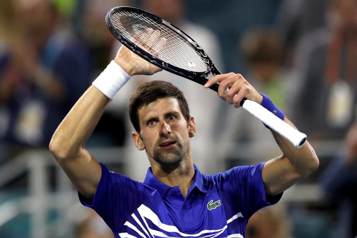 A closeup of Novak Djokovic celebrating after a victory.