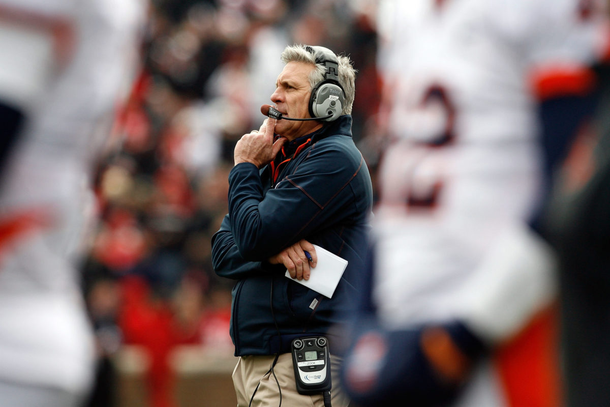 Ron Zook with his hand on his chin while coaching Illinois