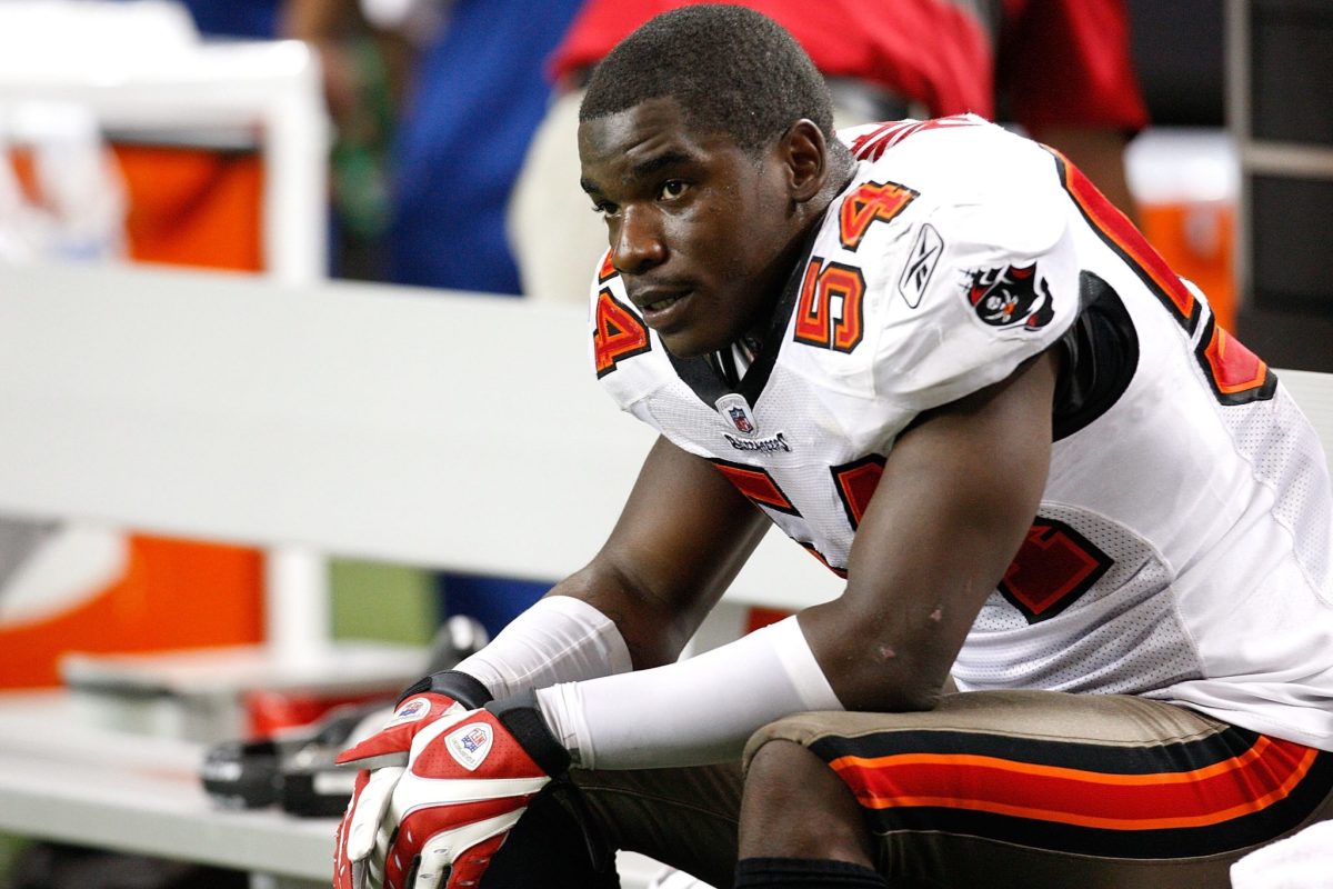 Geno Hayes #54 of the Tampa Bay Buccaneers sits on the bench