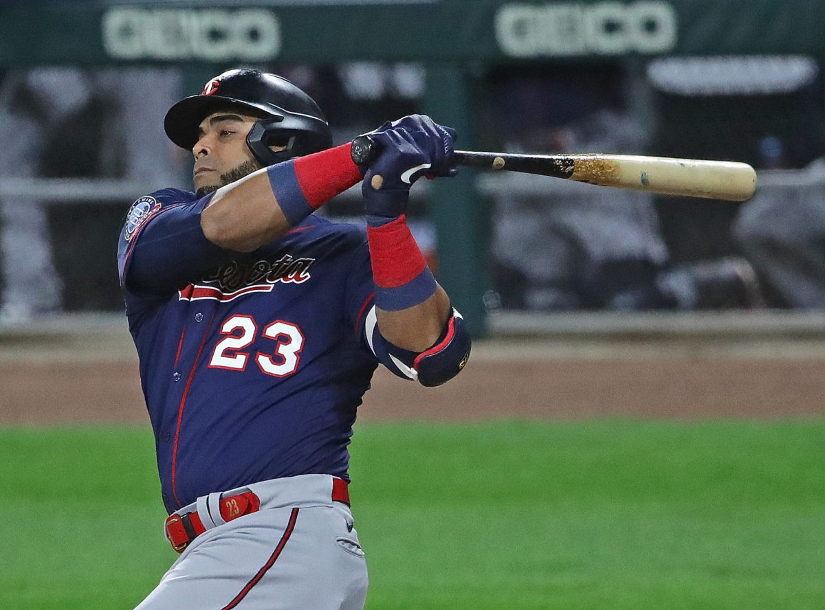 Nelson Cruz of the Twins swinging a bat and looking at the ball.