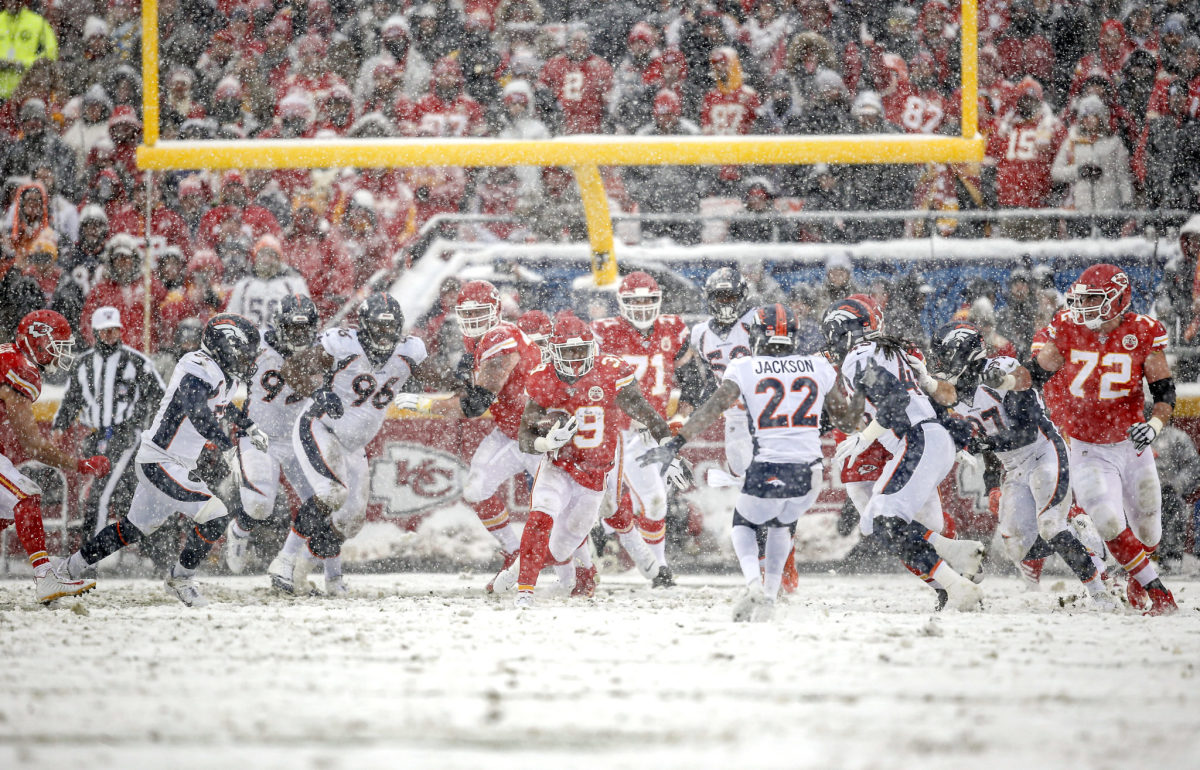 Broncos and Chiefs play in the snow.