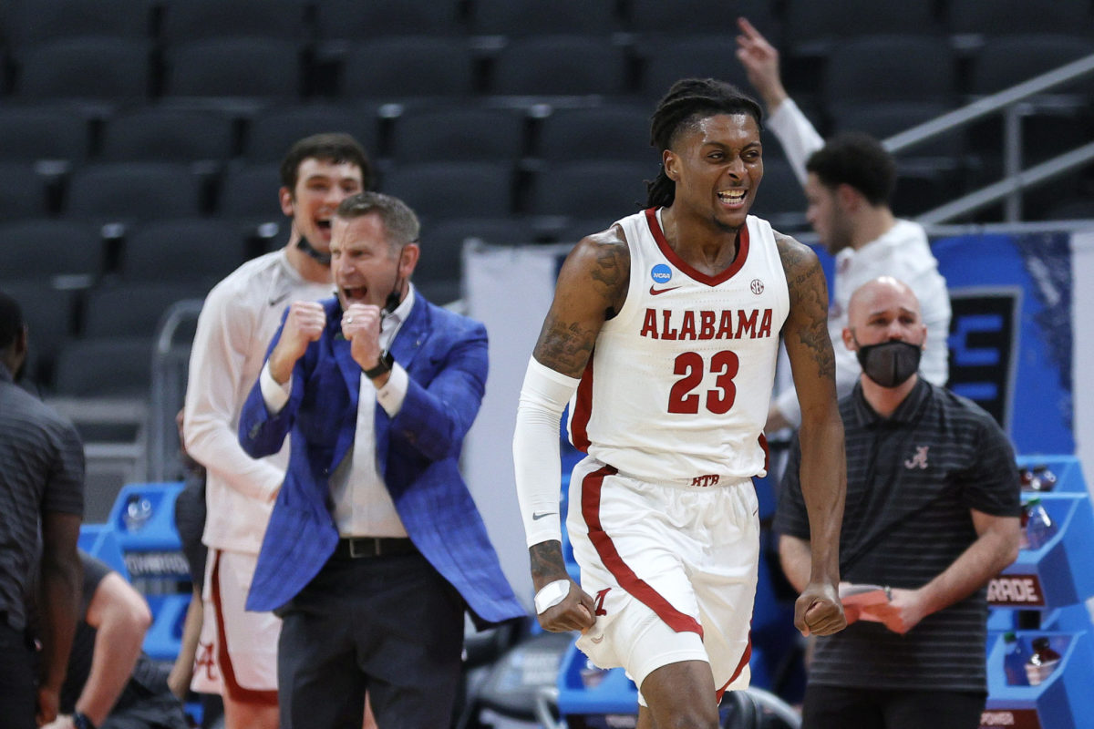 John Petty Jr. #23 of the Alabama Crimson Tide reacts as head coach Nate Oats looks on in the second half against the Maryland Terrapins in the second round game of the 2021 NCAA Men's Basketball Tournament