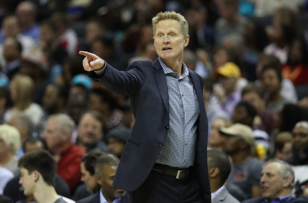 Golden State Warriors coach Steve Kerr pointing during a game.
