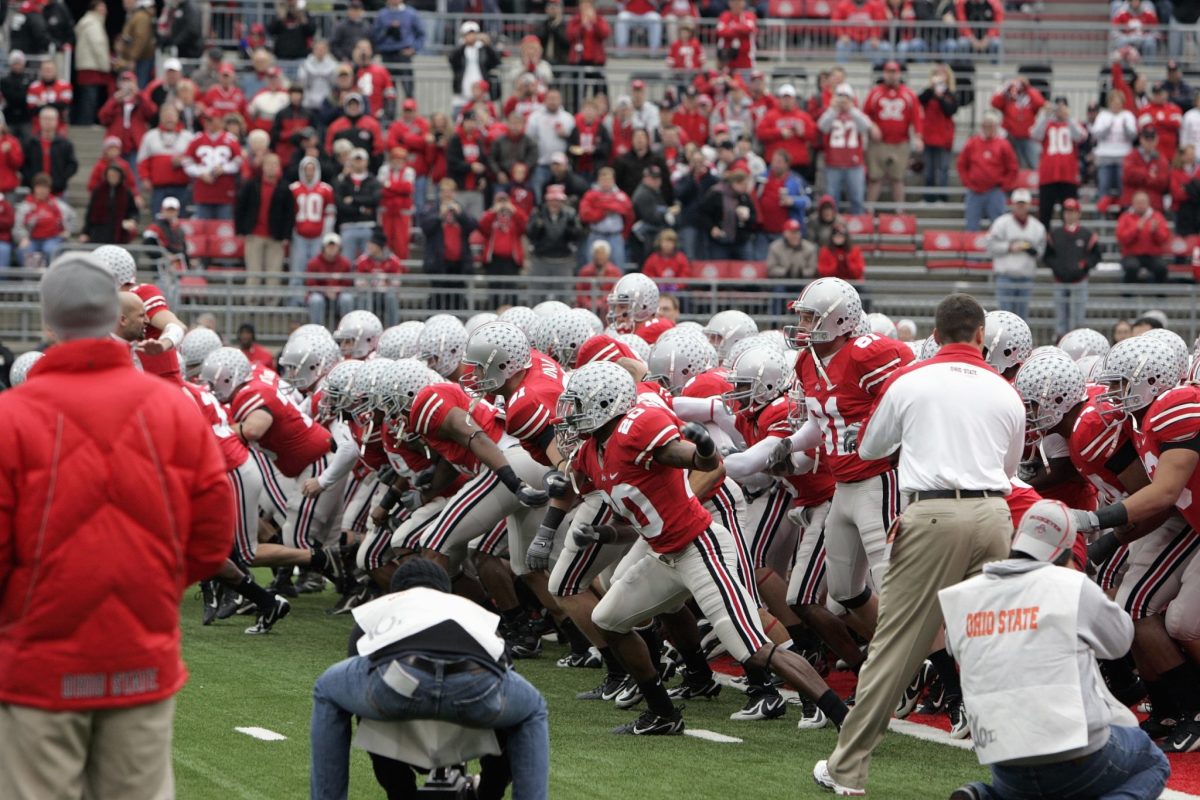 Ohio State football players running onto the field.