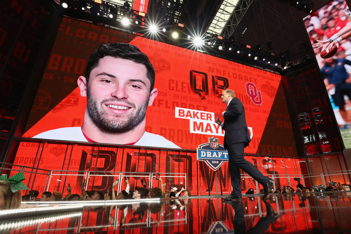 NFL Commissioner Roger Goodell walks past a video board displaying an image of Baker Mayfield of Oklahoma after he was picked #1 overall by the Cleveland Browns.